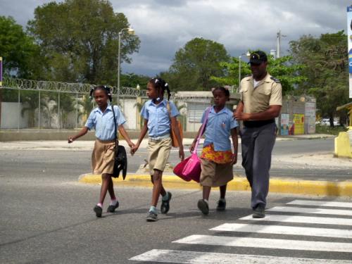 policeman and students crossing street