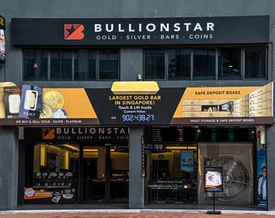 storefront shop with gold coins and bars